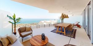 salon ze stołem i krzesłami i widokiem na ocean w obiekcie Stupa Hills IV F33G - Superb Sea View Apartment w mieście Benalmádena