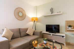 Televízia a/alebo spoločenská miestnosť v ubytovaní Teatro Suites Málaga CITY FLAT