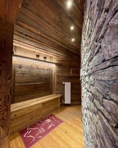 a room with a sauna with a stone wall at La Maison Derby in La Salle