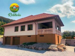 a house with a balcony on top of it at Relikvia in Sovata