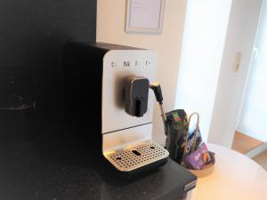 a coffee machine with a phone in it on a counter at Brands Loft in Hamburg