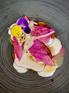 a plate with a dessert with a flower on it at Hotel Jedlinka in Jedlina-Zdrój