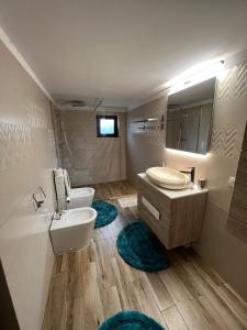 a bathroom with a sink and a toilet and a mirror at Pensiunea Cassandra in Târgu Neamț +28 photos