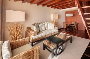 a living room with a couch and a table at Crowne Plaza Vilamoura - Algarve by IHG in Vilamoura