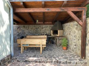 a patio with a wooden table and a stove at Holiday Home Banská Štiavnica in Banská Štiavnica +23 photos