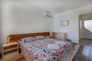 a bedroom with a bed with a wooden head board at Saint George Hotel 2 in Kavarna