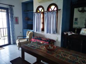 a living room with a table and a couch at Maria's Studios in Afissos