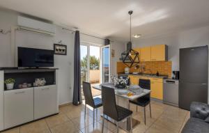 a kitchen and dining room with a table and chairs at E&M in Senj