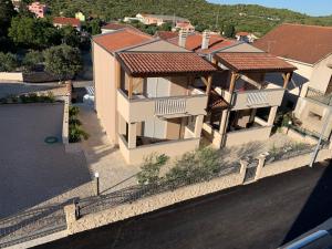 an aerial view of a house with a roof at Apartments Mais Tisno in Tisno