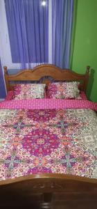 a bedroom with a bed with a quilt on it at Apartmani Lazić in Pluzine