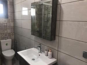 a bathroom with a sink and a toilet and a mirror at Aegean Mirror, Andros in Apróvaton +102 photos
