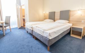 a bedroom with a large bed and a chair at Jordan Pokoje Gościnne in Krakow +66 photos