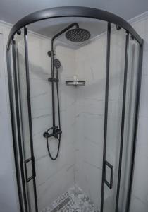 a shower with a glass door in a bathroom at Cozy Loft with Private Terrace in Kremasti