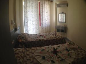A bed or beds in a room at Semiz Apart Hotel