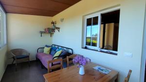 a living room with a table and a couch at Iraña del bosque in Breña Baja