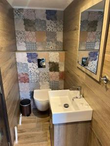 a bathroom with a sink and a toilet at Theokleia_guest house in Kavála +35 photos