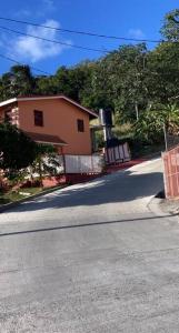 a street with a house and a road with at Homely environment ideal for a home away from home in Gros Islet