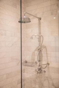 a shower with a glass door in a bathroom at The Roseate Villa Bath in Bath
