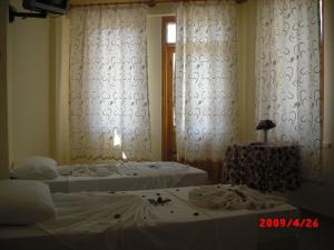 A bed or beds in a room at Semiz Apart Hotel