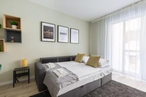 A bed or beds in a room at Second Home Apartment