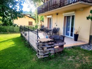 taras ze stołem i krzesłami na domu w obiekcie Maison de vacances au cœur de la Cerdagne w mieście Angoustrine