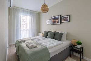 A bed or beds in a room at Second Home Apartment