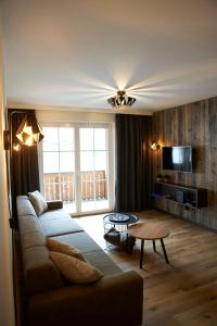 a living room with a couch and a table at Appartement Iglsberg Top 6 in Saalbach-Hinterglemm