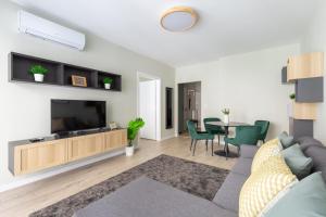 A television and/or entertainment centre at Second Home Apartment