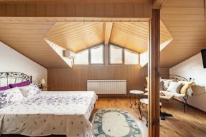 a bedroom with a bed and a large window at Guest House Geranium Arbanasi in Arbanasi