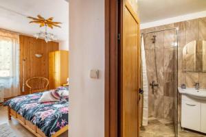 a bedroom with a bed and a shower and a sink at Guest House Geranium Arbanasi in Arbanasi +43 photos