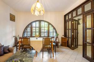 a living room with a table and chairs and a chandelier at Guest House Geranium Arbanasi in Arbanasi
