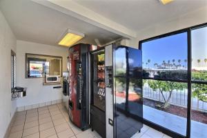 a room with a soda machine and a view of the ocean at Motel 6-Laredo, TX - South in Laredo