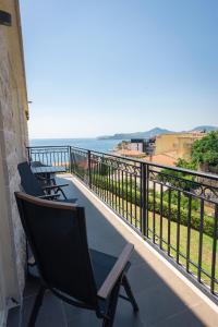 a balcony with chairs and a view of the ocean at Vertmont Villa in Sveti Stefan
