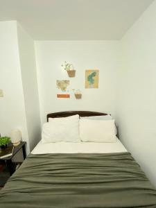 a bedroom with a bed with white walls at RUSTIC THEMED - 2BR TownHouse - near Clark Airport - TRP4 in Mining