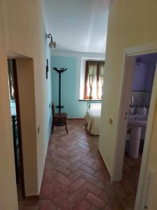a hallway with a room with a bed and a sink at Agriturismo Il Giovannello in Roccastrada +49 photos