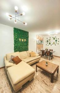 a living room with a couch and a table at RUSTIC THEMED - 2BR TownHouse - near Clark Airport - TRP4 in Mining