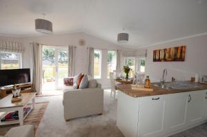 a kitchen and living room with a couch and a table at Hollicarrs Holiday Park - Hares Leap in Riccall