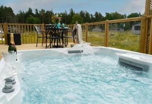 a person is spraying water into a swimming pool at Hollicarrs Holiday Park - Hares Leap in Riccall