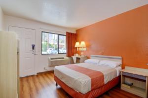 a bedroom with a bed and a dresser at Motel 6-Palm Springs, CA - East - Palm Canyon in Palm Springs