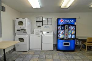 a kitchen with a refrigerator and a table at Motel 6-Palm Springs, CA - East - Palm Canyon in Palm Springs