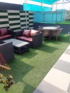 a patio with chairs and tables on a roof at Nature's Blessing in Chandīgarh