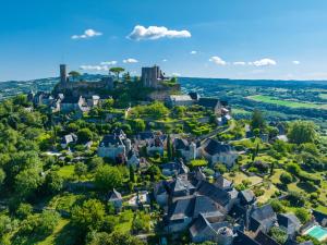 an aerial view of a small town with a castle at Logis Hotel Noemys Brive - Restaurant Le Teinchurier in Brive-la-Gaillarde