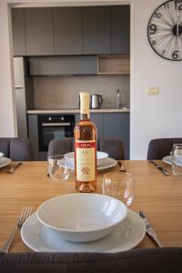 a bottle of wine sitting on a table with glasses at Vertmont Villa in Sveti Stefan