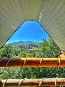 a view of the mountains from a window of a porch at Lavender House in Slavske