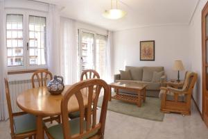 a living room with a couch and a table and chairs at Apartamentos La Terraza in Laredo