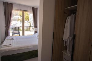 a bedroom with a bed and a door to a balcony at Vertmont Villa in Sveti Stefan