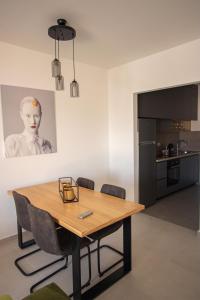 a dining room with a wooden table and chairs at Vertmont Villa in Sveti Stefan