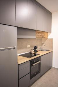 a kitchen with white cabinets and a sink at Vertmont Villa in Sveti Stefan