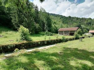 a house in a field next to a river at Best Price #A "LA REMISE" x4 people in Lods
