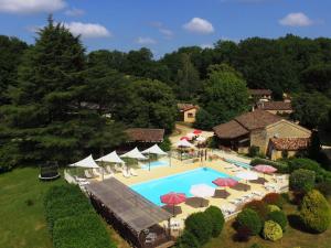 an aerial view of a swimming pool with chairs and umbrellas at Domaine de Gavaudun in Gavaudun